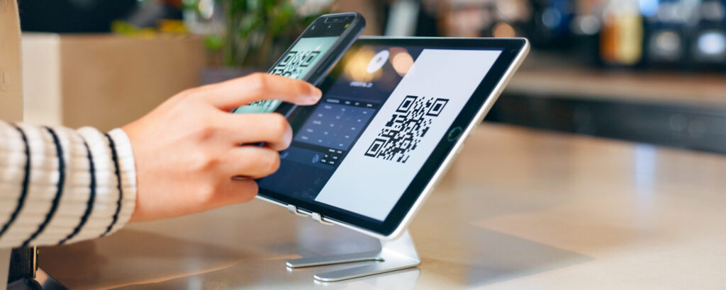 Customer using a QR code for digital payment in a coffee shop