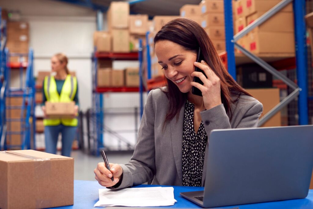 Sales person taking order from a client on a phone call. Choosing a B2B ecommerce platform for strategic business growth